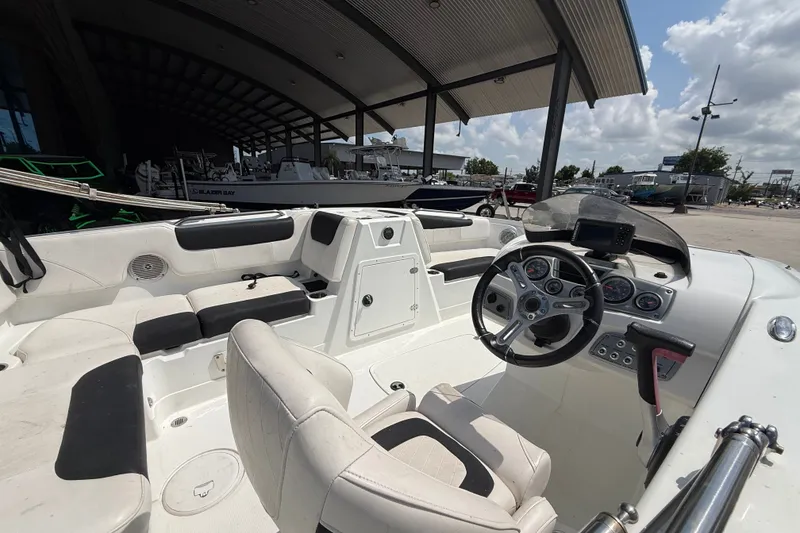 Slide: The Image of Interior of a 2017 Tahoe 1950 boat with steering wheel and seating under a canopy. - 9