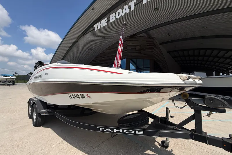 Slide: The Image of Tahoe 1950 boat on trailer, 2017 model, parked outside a boat dealership. - 7