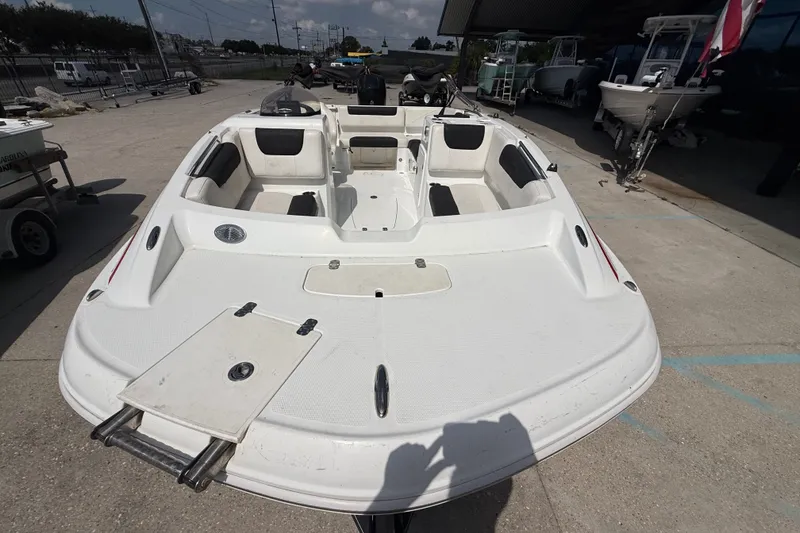 Slide: The Image of 2017 Tahoe 1950 boat with spacious seating, docked outdoors under a clear sky. - 8