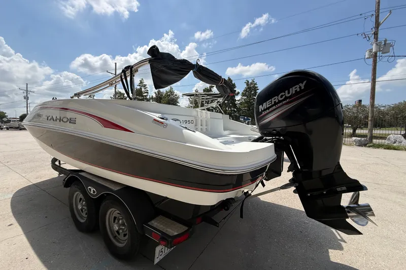 Slide: The Image of 2017 Tahoe 1950 boat with Mercury outboard motor on trailer under blue sky. - 4