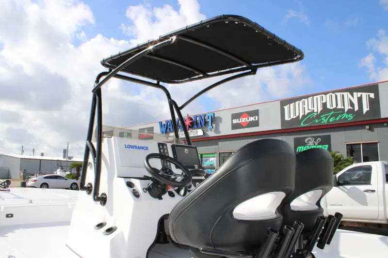 Slide: The Image of 2026 Mamba 24 Cat Elite boat with dual seats and canopy at dealership. - 21
