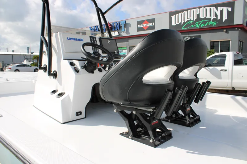 Slide: The Image of 2026 Mamba 24 Cat Elite boat interior with dual black seats and steering console. - 20
