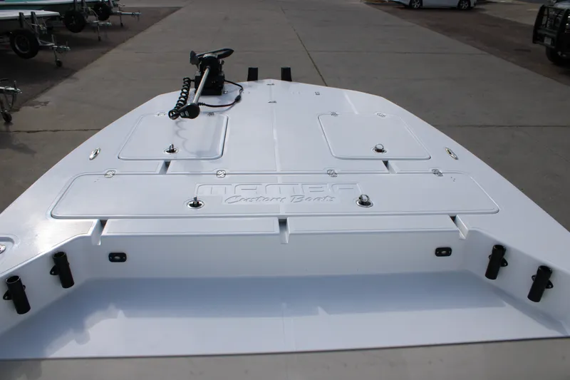 Slide: The Image of 2026 Mamba 24 Cat Elite boat deck with storage compartments and trolling motor. - 13