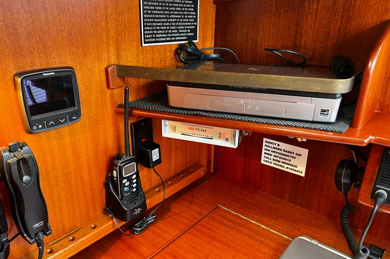 Slide: The Image of Navigation equipment inside a 1997 Hallberg-Rassy 42F yacht cabin. - 26