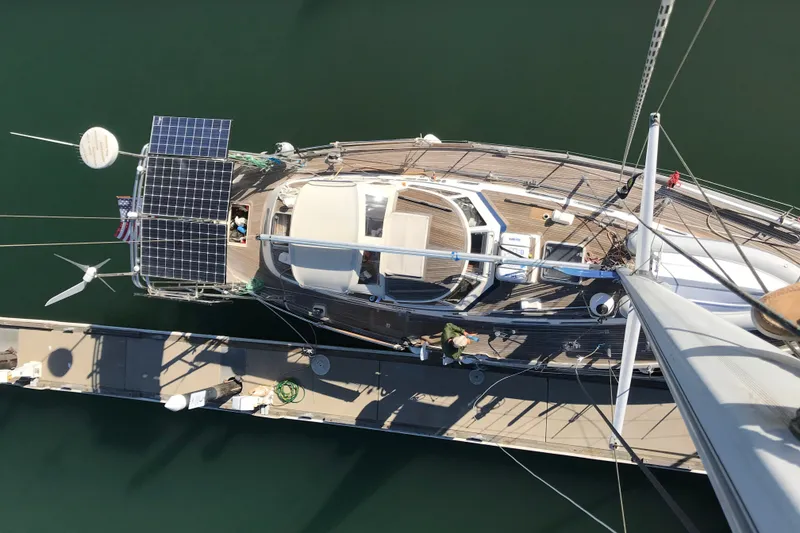 Slide: The Image of Aerial view of 1997 Hallberg-Rassy 42F yacht with solar panels docked at marina. - 99