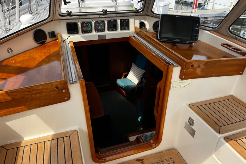 Slide: The Image of Cockpit of 1997 Hallberg-Rassy 42F sailboat with wooden trim and navigation equipment. - 61