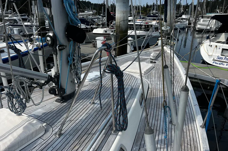Slide: The Image of Deck view of a 1997 Hallberg-Rassy 42F sailboat docked at a marina. - 37