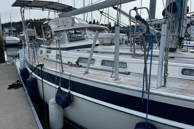 Slide: The Image of 1997 Hallberg-Rassy 42F sailboat docked at marina, featuring sleek design and sturdy build. - 72