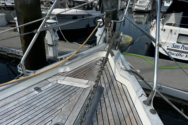 Slide: The Image of Bow of a 1997 Hallberg-Rassy 42F yacht docked at a marina. - 40