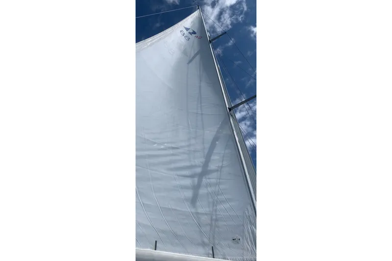 Slide: The Image of Sail of a 1997 Hallberg-Rassy 42F yacht against a blue sky. - 96