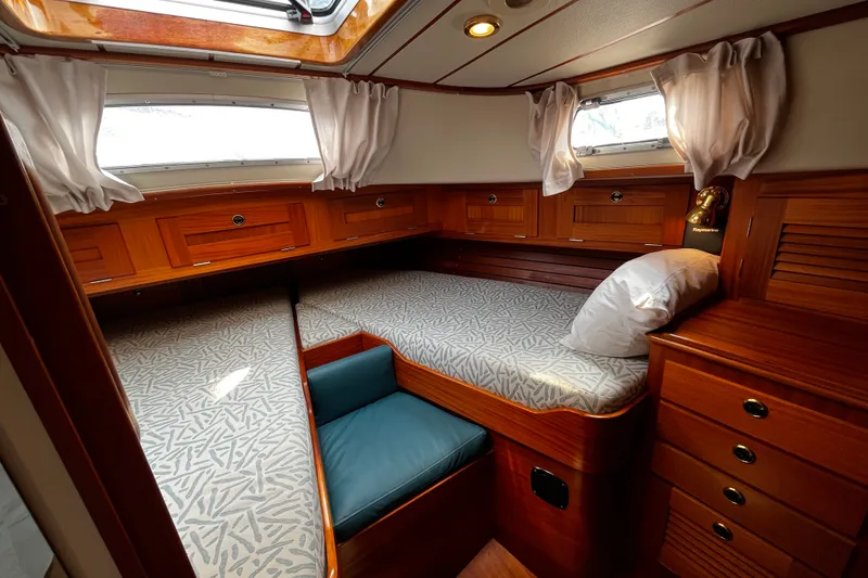 Slide: The Image of Cozy cabin interior of 1997 Hallberg-Rassy 42F sailboat with wooden furnishings and bedding. - 14