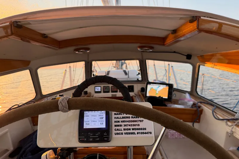 Slide: The Image of Cockpit view of 1997 Hallberg-Rassy 42F sailboat at sunset, featuring navigation equipment. - 93