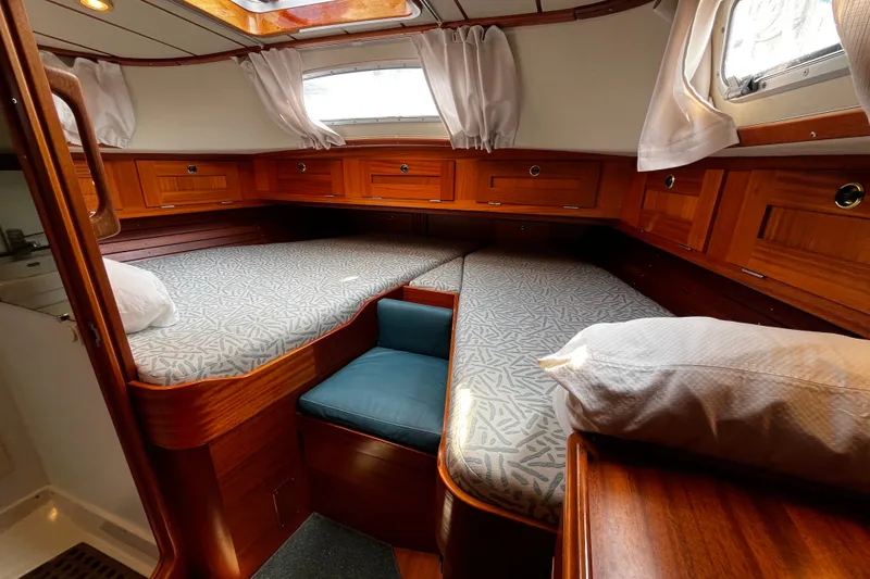 Slide: The Image of Cozy cabin interior of 1997 Hallberg-Rassy 42F sailboat with wooden finish and twin beds. - 13