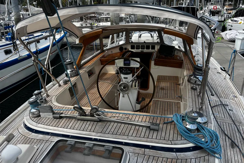 Slide: The Image of Cockpit of a 1997 Hallberg-Rassy 42F sailboat with wooden deck and steering wheel. - 65