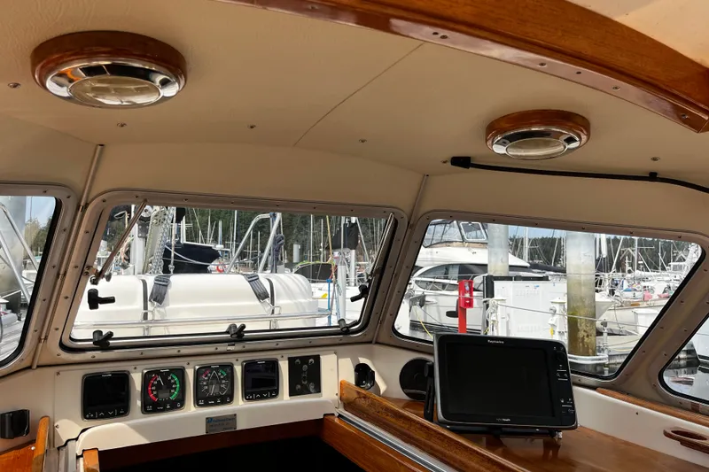 Slide: The Image of Interior view of a 1997 Hallberg-Rassy 42F yacht cockpit with navigation equipment. - 60