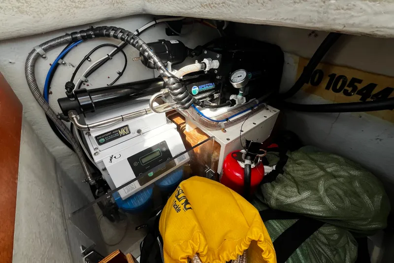 Slide: The Image of Engine compartment of 1997 Hallberg-Rassy 42F yacht with equipment and storage items. - 84