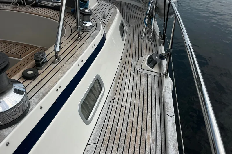 Slide: The Image of Deck of 1997 Hallberg-Rassy 42F sailboat with teak wood and stainless steel fittings. - 67