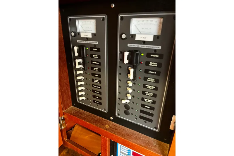 Slide: The Image of Electrical panel of a 1997 Hallberg-Rassy 42F sailboat, featuring various switches and meters. - 22