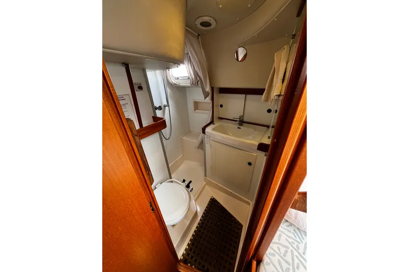 Slide: The Image of Bathroom interior of 1997 Hallberg-Rassy 42F yacht, featuring sink, toilet, and shower. - 17
