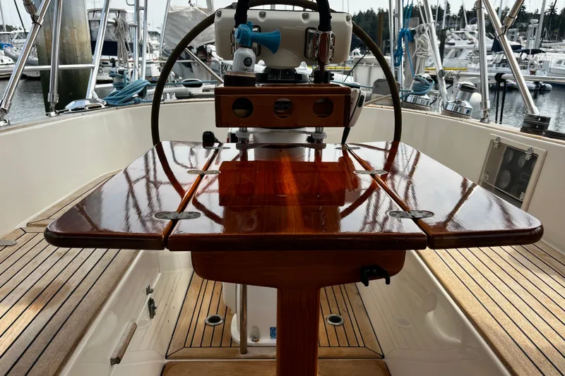 Slide: The Image of Cockpit of 1997 Hallberg-Rassy 42F sailboat with polished wooden table and steering wheel. - 82