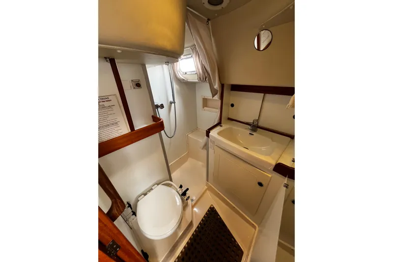 Slide: The Image of Bathroom interior of 1997 Hallberg-Rassy 42F yacht, featuring sink, toilet, and shower. - 18