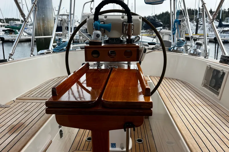 Slide: The Image of Cockpit of 1997 Hallberg-Rassy 42F sailboat with wooden table and steering wheel. - 81