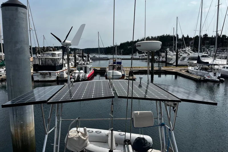 Slide: The Image of Sailboat with solar panels and wind turbine in marina, Hallberg-Rassy 42F, 1997 model. - 64