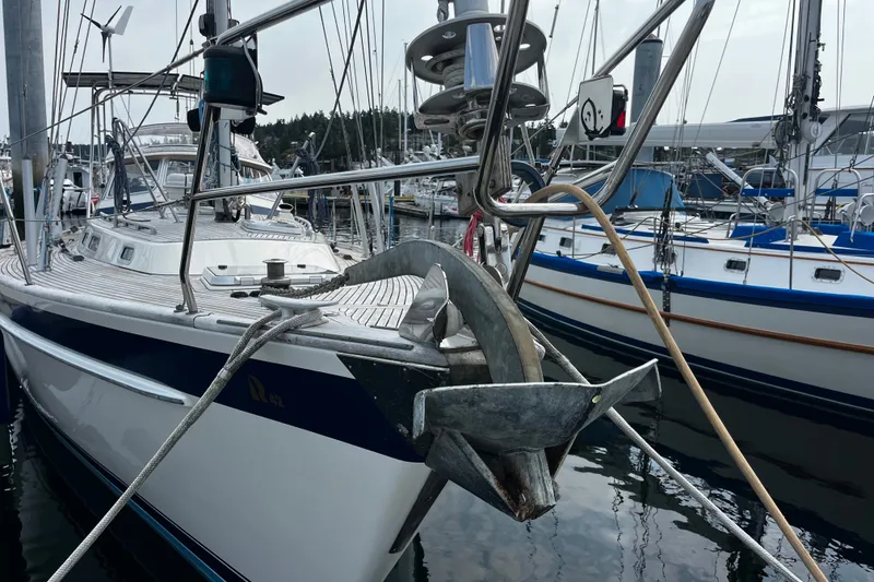 Slide: The Image of 1997 Hallberg-Rassy 42F sailboat docked, featuring anchor and deck details. - 70