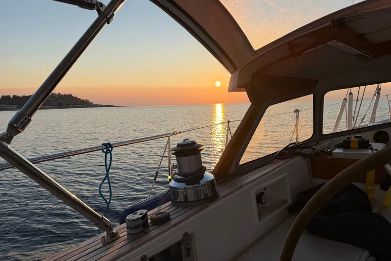 Slide: The Image of Sailing on a 1997 Hallberg-Rassy 42F at sunset, serene ocean view. - 94