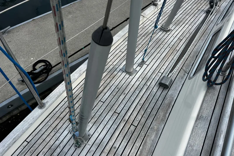 Slide: The Image of Deck of 1997 Hallberg-Rassy 42F sailboat with rigging and wooden planks. - 43