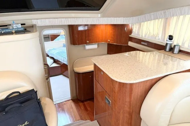 Slide: The Image of Interior of 2004 Sea Ray 390 Motor Yacht with elegant wood cabinetry and seating. - 21