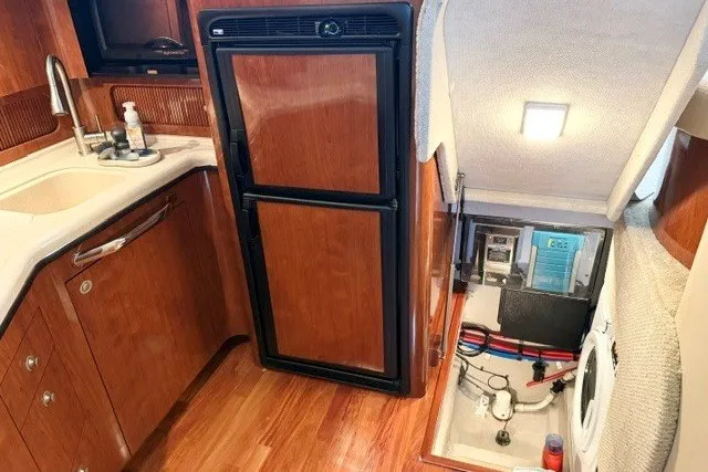 Slide: The Image of 2004 Sea Ray 390 Motor Yacht interior with kitchen and storage area. - 47