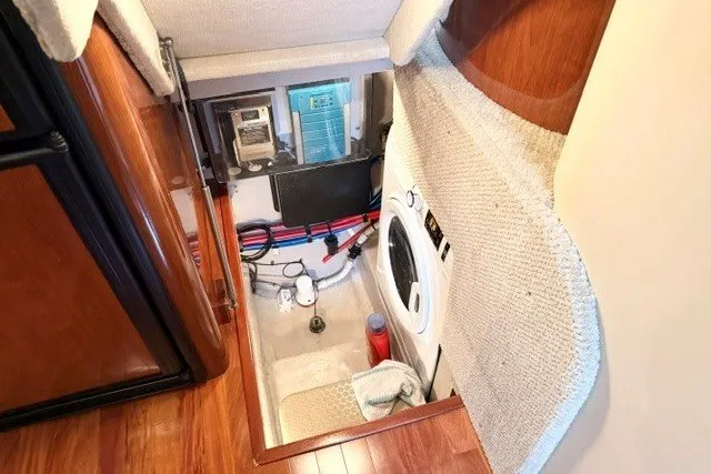Slide: The Image of 2004 Sea Ray 390 Motor Yacht interior with laundry area and equipment access. - 45