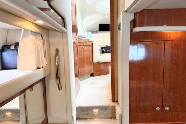 Slide: The Image of Interior of 2004 Sea Ray 390 Motor Yacht with wood cabinetry and cozy seating. - 20