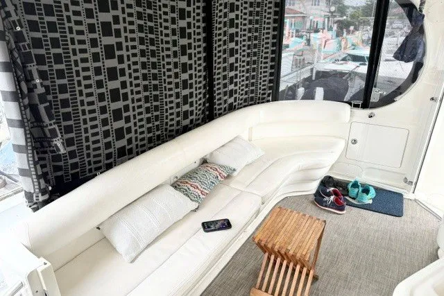 Slide: The Image of Luxurious 2004 Sea Ray 390 Motor Yacht interior with white seating and modern decor. - 5