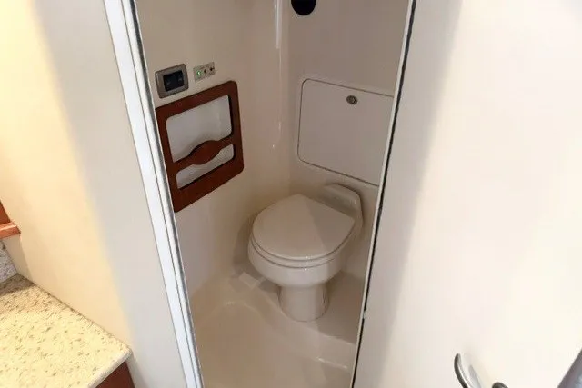 Slide: The Image of 2004 Sea Ray 390 Motor Yacht bathroom with modern amenities and compact design. - 16