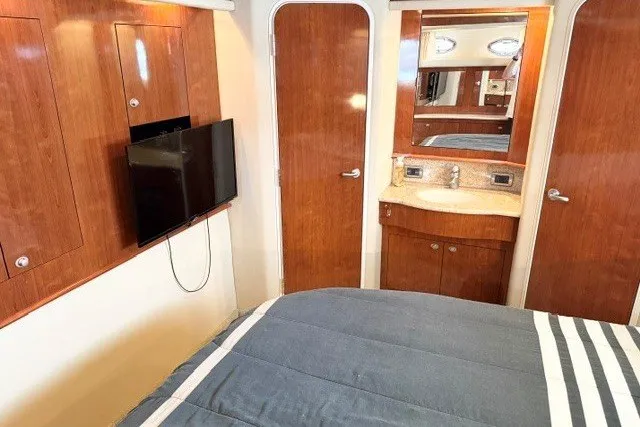 Slide: The Image of Interior of 2004 Sea Ray 390 Motor Yacht with wood cabinetry and mounted TV. - 18
