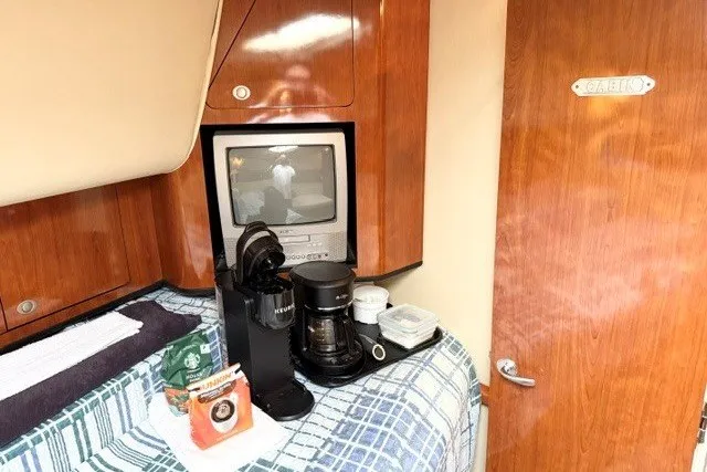 Slide: The Image of 2004 Sea Ray 390 Motor Yacht interior with coffee maker and TV in cabin. - 31