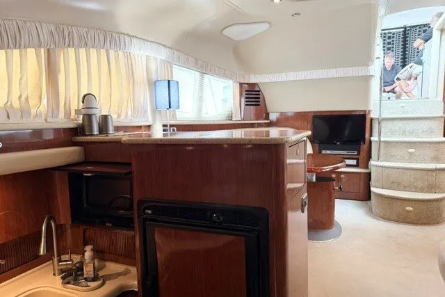 Slide: The Image of Interior of 2004 Sea Ray 390 Motor Yacht with kitchen and seating area. - 24