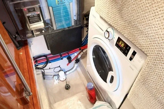Slide: The Image of Laundry area in a 2004 Sea Ray 390 Motor Yacht with washer and electrical panel. - 46