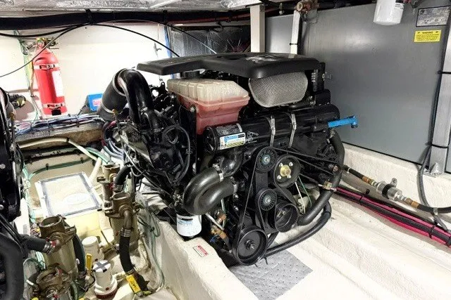 Slide: The Image of Engine room of 2004 Sea Ray 390 Motor Yacht, showcasing detailed mechanical components. - 49