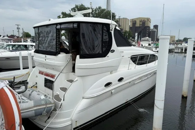 Slide: The Image of 2004 Sea Ray 390 Motor Yacht docked at marina, featuring sleek white design. - 4