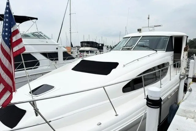 Slide: The Image of 2004 Sea Ray 390 Motor Yacht docked with American flag displayed. - 42