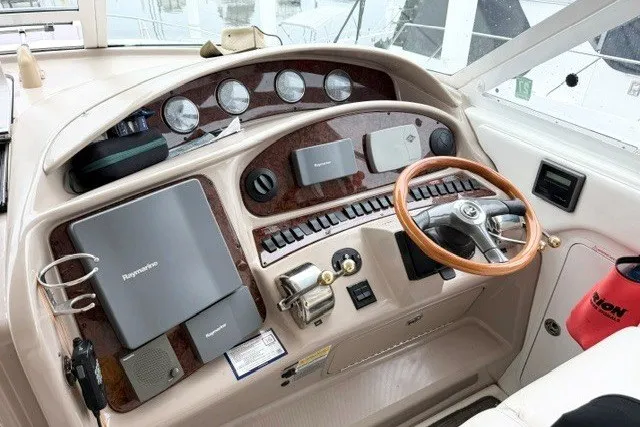 Slide: The Image of 2004 Sea Ray 390 Motor Yacht helm with steering wheel and navigation instruments. - 37