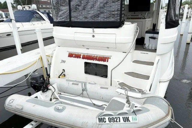 Slide: The Image of 2004 Sea Ray 390 Motor Yacht docked with inflatable boat attached. - 44