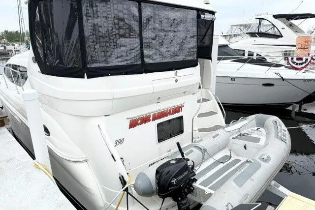 Slide: The Image of 2004 Sea Ray 390 Motor Yacht docked with inflatable boat attached. - 2