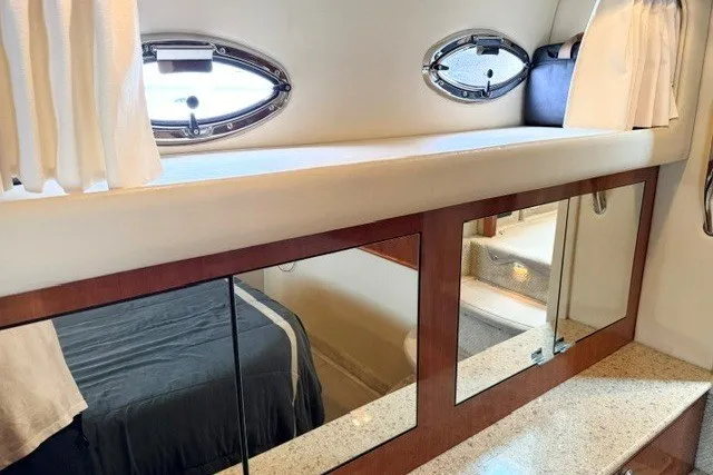 Slide: The Image of Luxurious interior of 2004 Sea Ray 390 Motor Yacht with mirrored cabinets and porthole windows. - 19