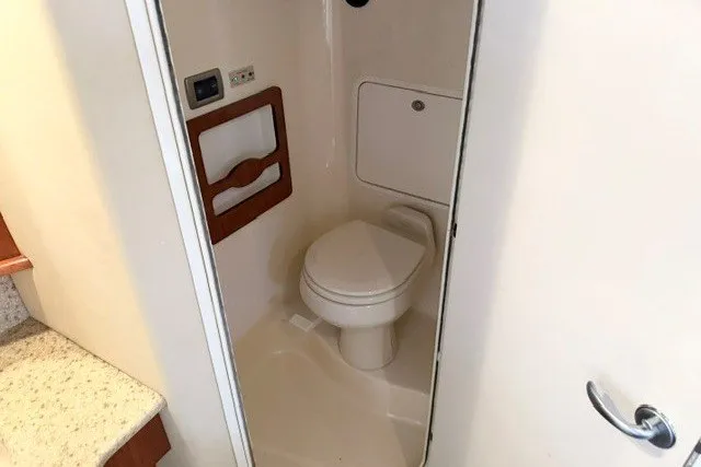 Slide: The Image of 2004 Sea Ray 390 Motor Yacht bathroom interior with toilet and storage. - 17
