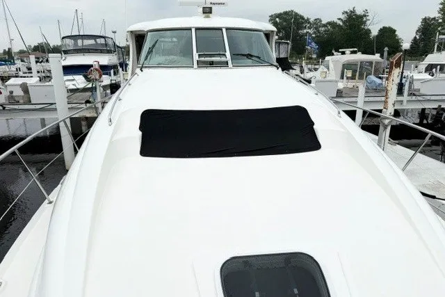 Slide: The Image of 2004 Sea Ray 390 Motor Yacht docked at marina, front view. - 41