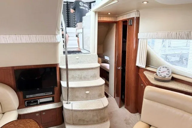 Slide: The Image of Interior of 2004 Sea Ray 390 Motor Yacht with stairs, TV, and seating area. - 9